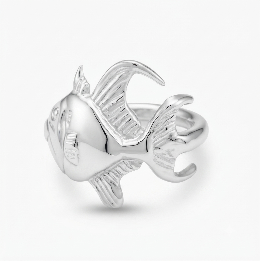 A polished silver fish-shaped ring with detailed fin and tail textures, shown on a clean white background.