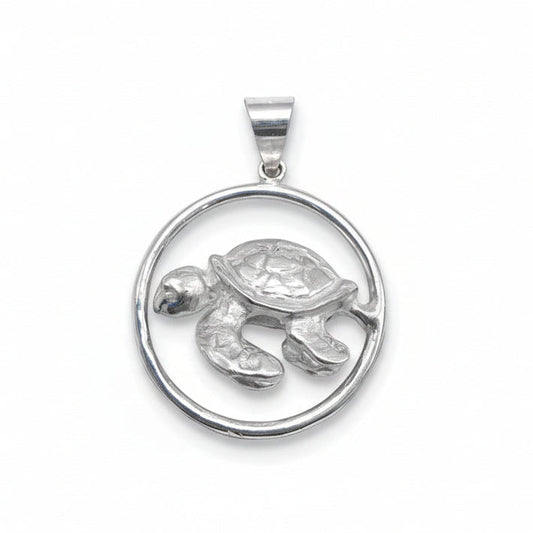 Silver turtle pendant on a white background