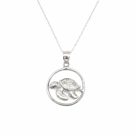 Silver necklace with a turtle pendant on a white background