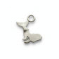 Silver charm shaped like a whale on a white background